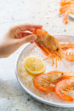 Plate of Shrimp Served With Lemon Wedges