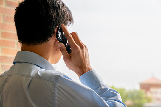 Back view businessman on talking on mobile phone