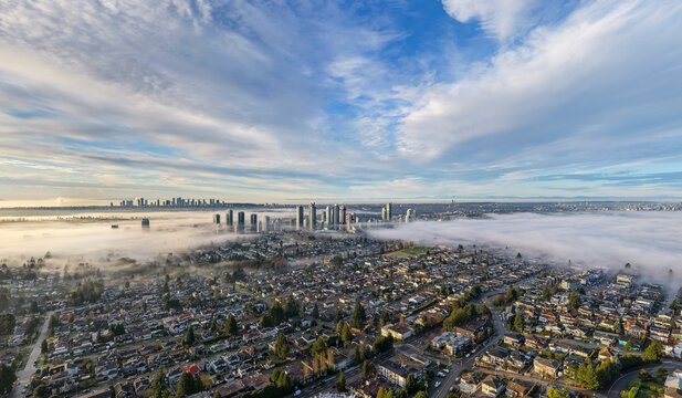 Aerial Morning Fog Over Burnaby Skyline and Suburban Neighbourhoods in Greater Vancouver, BC
