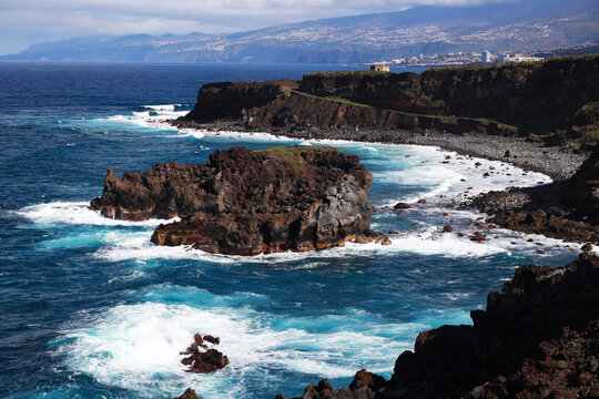Dramatic sea cliffs above beautiful beaches with powerful waves