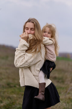 Cozy moments of mother and daughter outdoors