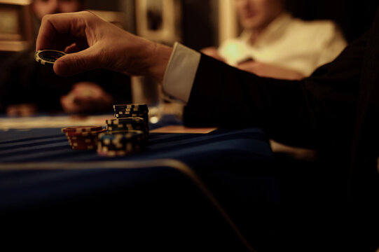 Engaging in poker at a dimly lit table