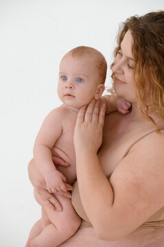close up portrait of young plus size mom with her baby