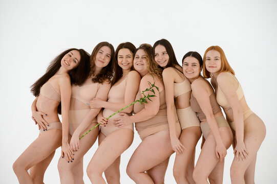 a group of happy female friends in underwear