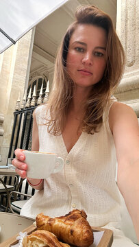 Brunette With Coffee and Croissant at Parisian Caf&eacute; Terrace