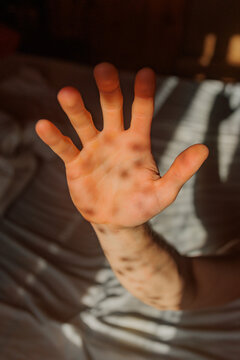 Hand Reaching out With Shadows on a Soft Surface in the Morning Light