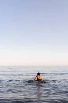 vertical image of a woman in the water
