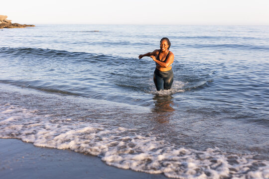 a woman doing sports on the beach