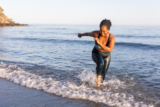 a woman doing sports on the beach