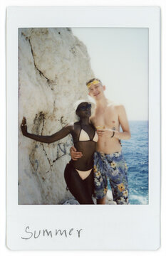 Couple Enjoys Sunny Day Near the Ocean on a Rocky Coastline