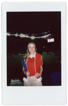 Fan Celebrates Soccer Match Wearing Team Jerseys at Stadium