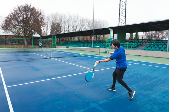 Tennis Player Hitting Forehand Return During Match