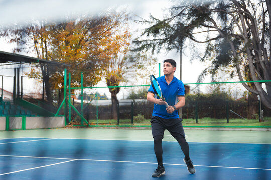Tennis Player Preparing to Return Shot on Outdoor Court