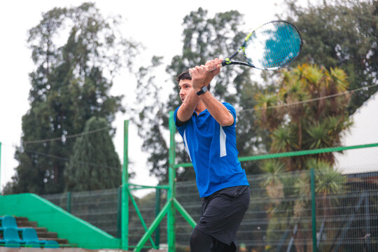Tennis Player Following Through After Powerful Backhand