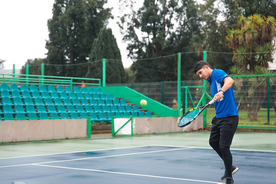 Tennis Player Focused on Backhand Return During Practice