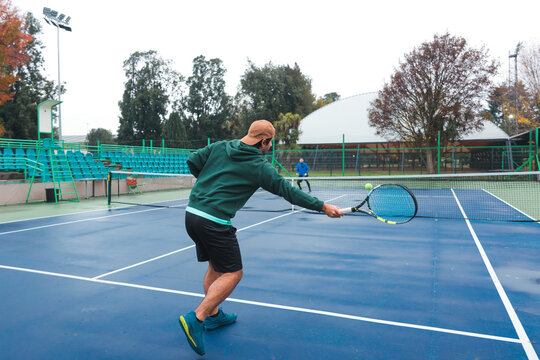 Tennis Player Prepares for Backhand Return During Match