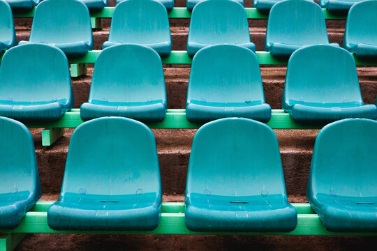 Rain-Dappled Stadium Seats in Empty Tennis Arena