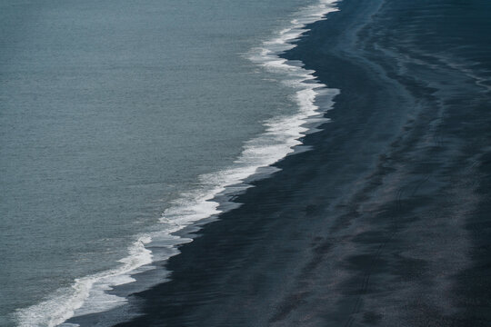 Waves crashing on black sand beach in Iceland 