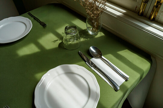 Table Setting With Natural Light and Floral Decoration in restaurant