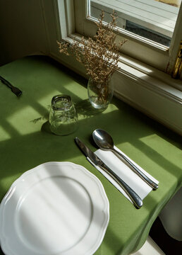 Table Setting With Natural Light and Floral Decoration in restaurant