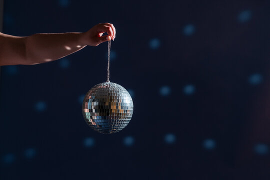Anonymous woman hand holding disco ball 