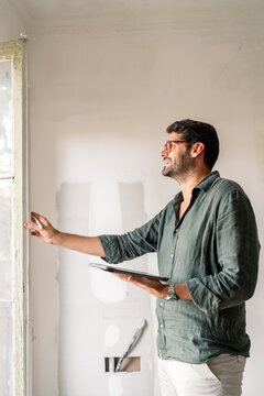 Architect Inspecting Window Area