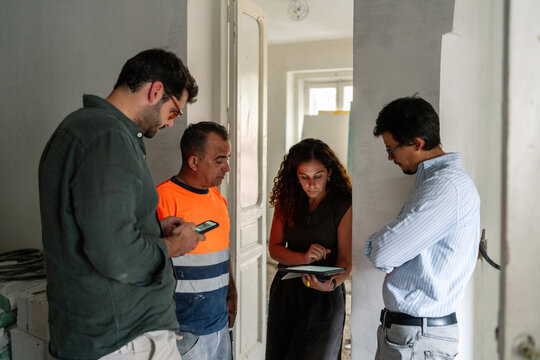 The renovation team Reviewing Interior Renovation Plans