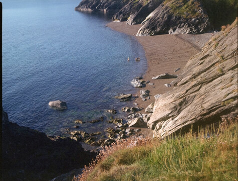 Swimmer with dog from a Rocky shoreline at Trivelahawk Beach Ireland