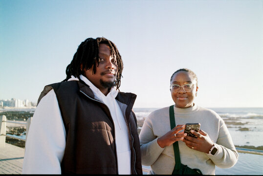 Portrait of couple walking near the ocean
