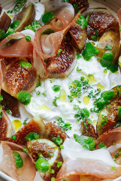 Close-up of burrata with figs and prosciutto