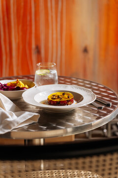 Gourmet appetizer with yellow topping on plate