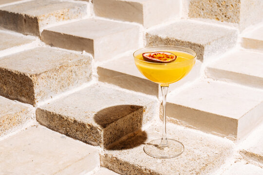 Passion fruit cocktail on stone steps