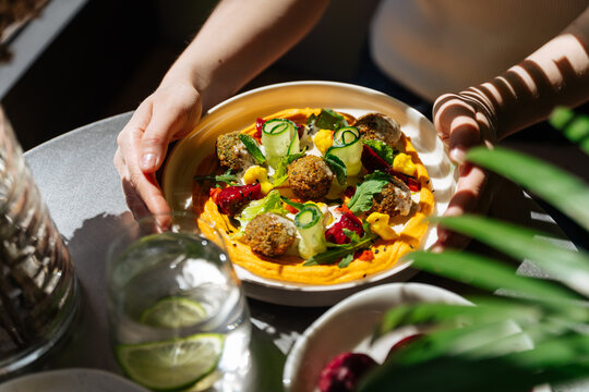 Colorful falafel platter with vegetables and hummus