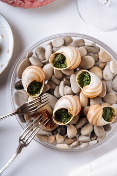 Escargot with herb butter served on pebbles