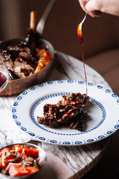 Plated braised lamb with sauce drizzle