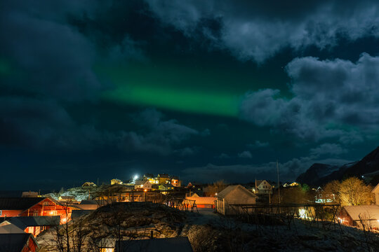 Traditional village under the dark sky with Aurora in Norway 