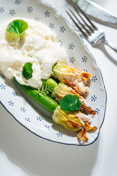 Title: Stuffed zucchini flowers with cream sauce - Description: 