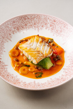 Grilled white fish with vegetables and orange sauce