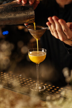 Bartender Pouring Yellow Cocktail