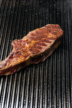 Grilled steak on hot ribbed grill pan