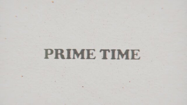 CMYK Halftone Text Prime Time Printed on Changing Paper with Vintage Stop Motion Effect.