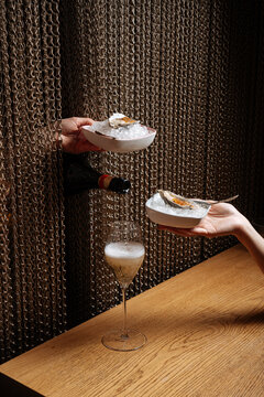 Oysters on ice and sparkling wine served through curtain