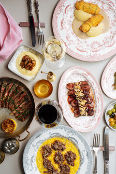 Assorted gourmet dishes with wine on elegant table setting