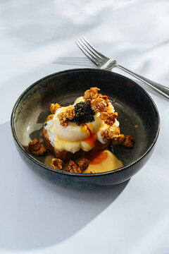 Poached egg on toast with caramel popcorn and caviar