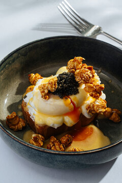 Gourmet dessert with whipped cream, caviar, and caramel popcorn