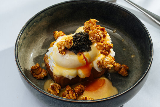 Gourmet toast with poached egg, caviar, and caramel popcorn