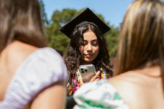 Recent Graduate Checks Phone