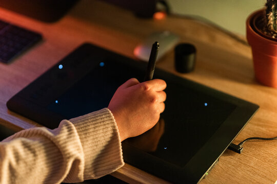 Creating Digital Art With a Stylus on a Tablet at Night