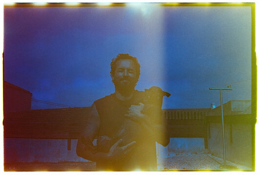 Man Holding Dog with Film Light Leak