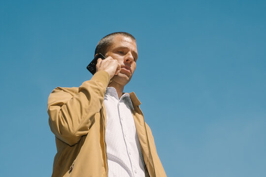 Man Talking on Mobile Phone Outdoors